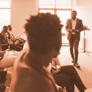 Man presenting to professionals in a training room