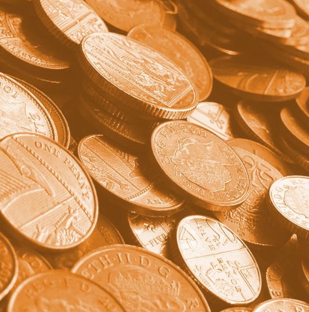 Mixed copper and silver coins scattered across a surface